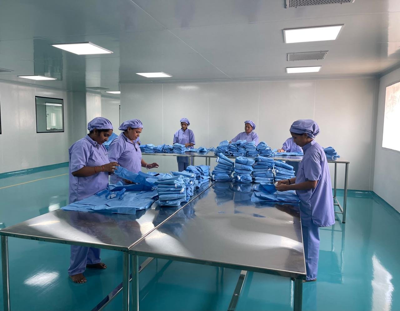 Cleanroom production floor at Bioanthem Devices with staff in protective gear inspecting surgical products